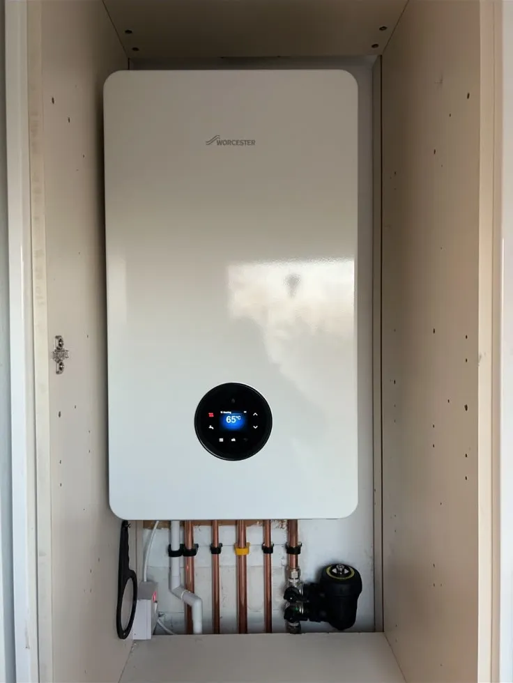 Worcester boiler in a cupboard with a magnetic system filter fitted