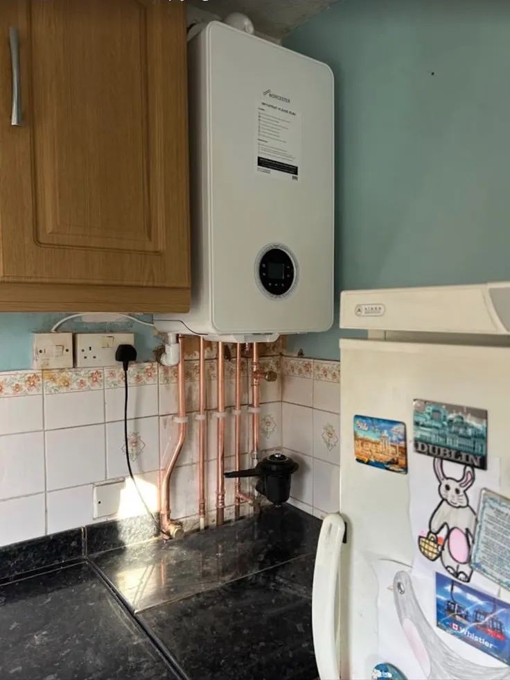 New Worcester boiler installed in a kitchen with copper pipework