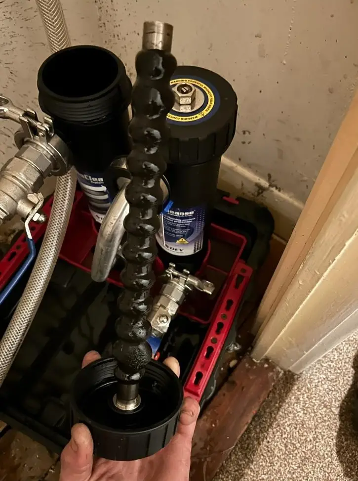 Magnetic filter cleaning showing collected sludge during boiler service by Buchanan Gas and Heating
