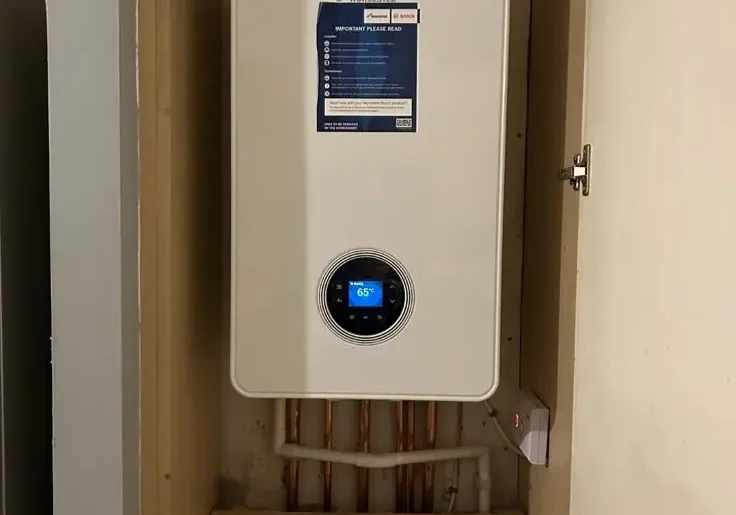 buchanan-gas-heating-worcester-boiler-custom-cupboard-installation Worcester boiler neatly installed in a custom cupboard with exposed copper pipework by Buchanan Gas and Heating